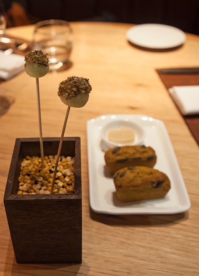 A crunchy apple amuse bouche with pumpkin bread and butter<br>